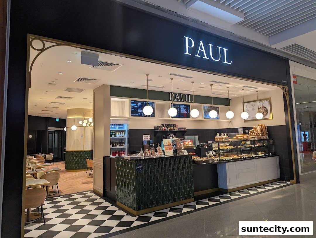 The PAUL bakery and cafe features a display of fresh pastries and breads, with seating visible inside.