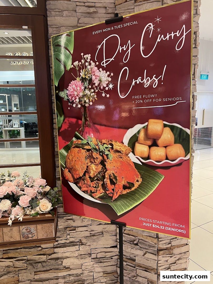 A promotional sign for Penang Place featuring Dry Curry Crabs with special offers.