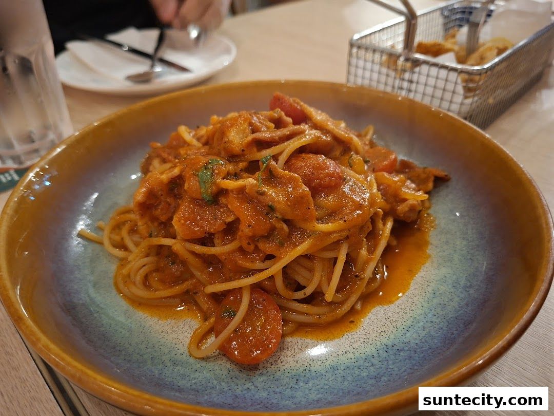 A close-up shot of a delicious pasta dish served in a rustic bowl at Peperoni Pizzeria.