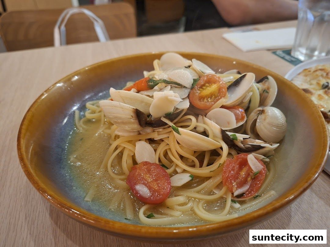 A close-up shot of a delicious pasta dish with clams and cherry tomatoes.