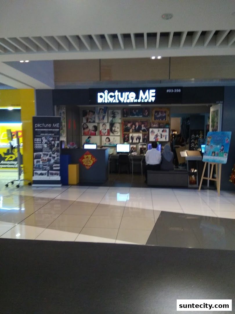 The Picture Me photo studio entrance with displays of photos and computers.