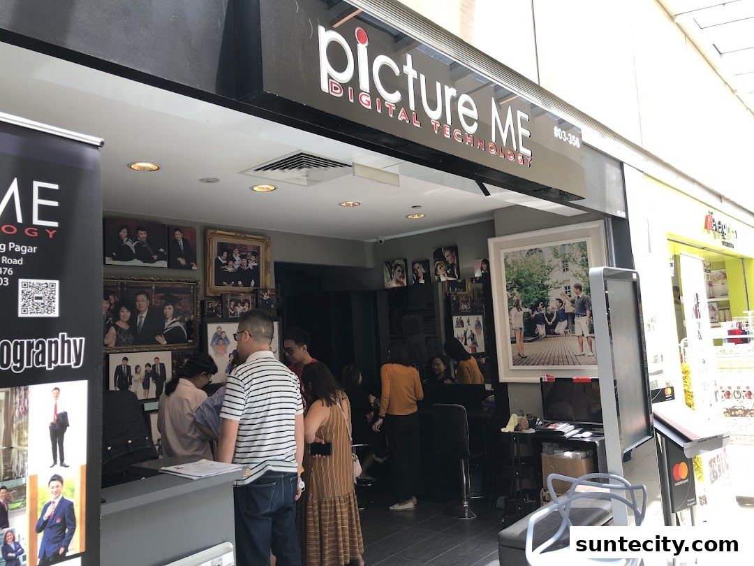 The exterior of a photography studio called "Picture Me" with framed photos displayed.