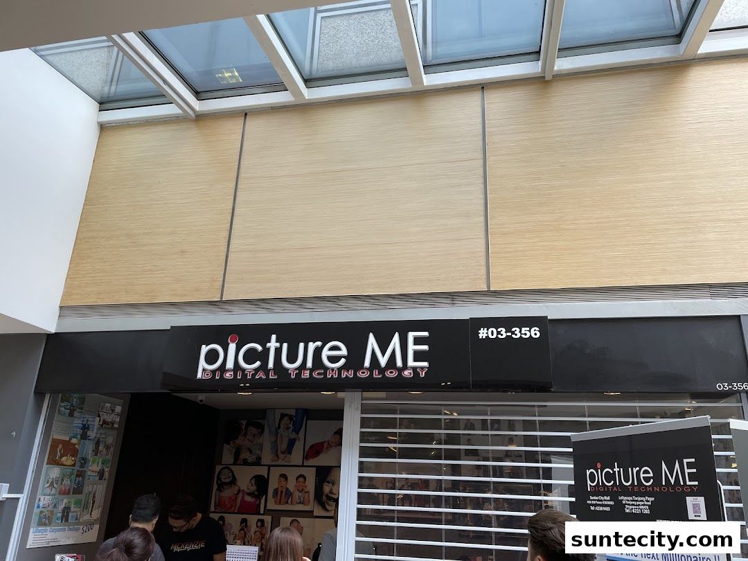 The exterior of a photography shop called 'Picture Me' with displayed photos and a sign.
