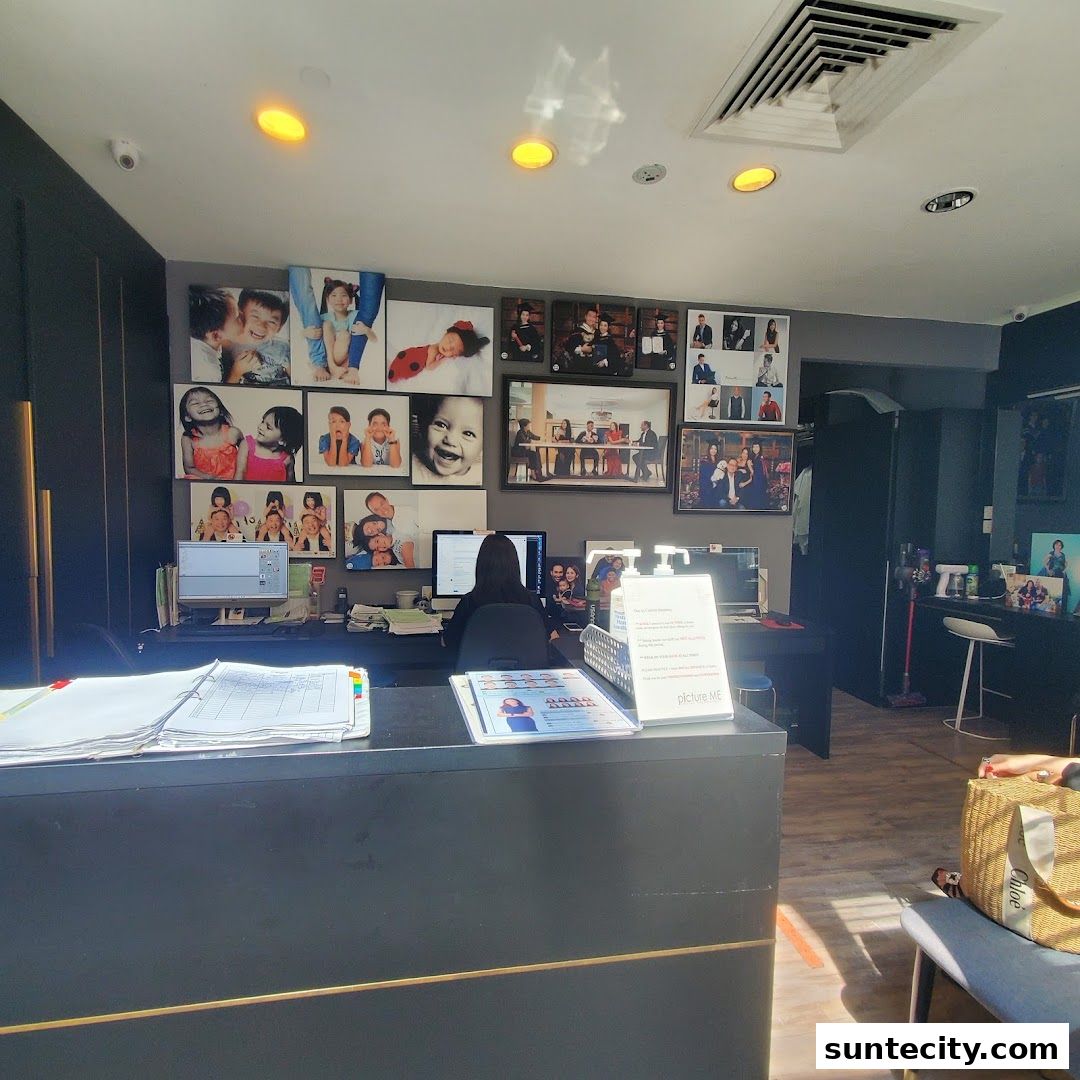 Interior of a photography studio with a reception desk and displayed portraits.