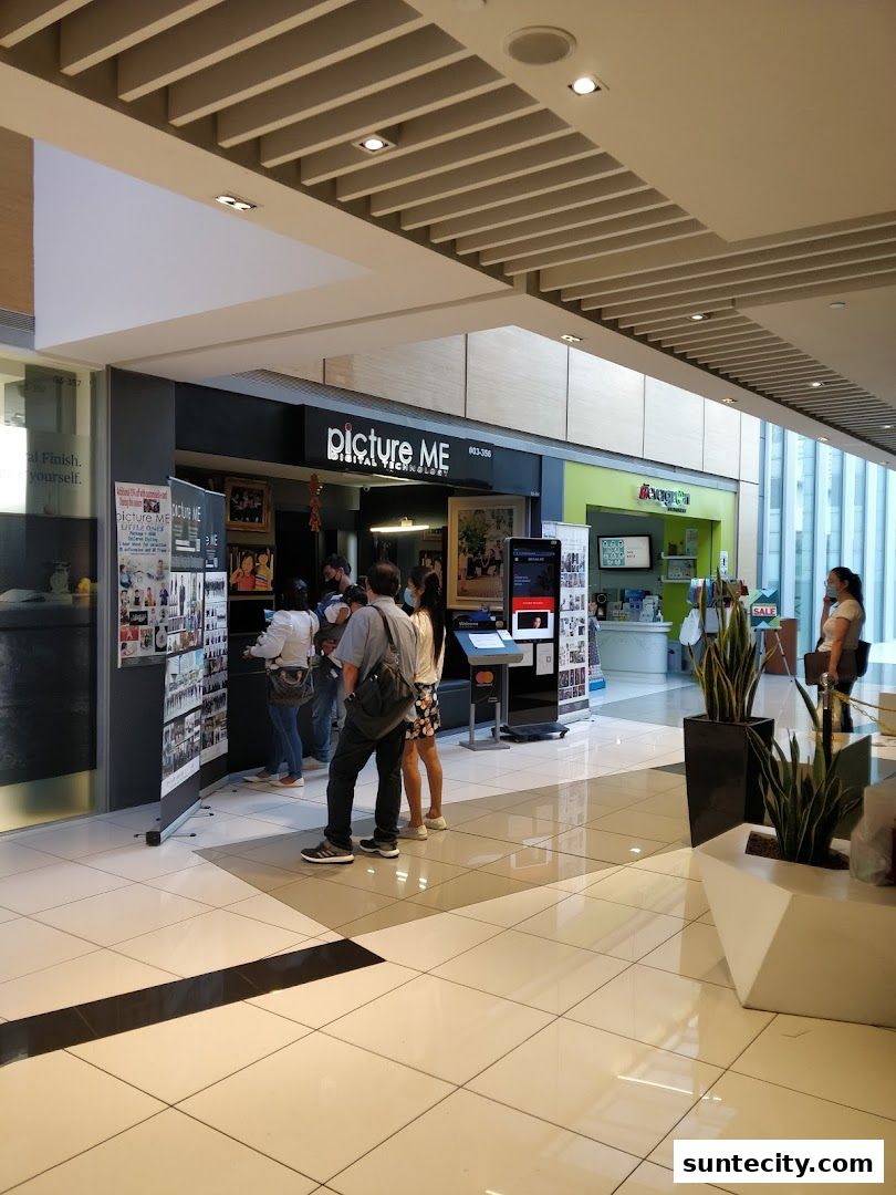 People looking at displays outside the Picture Me digital technology shop.