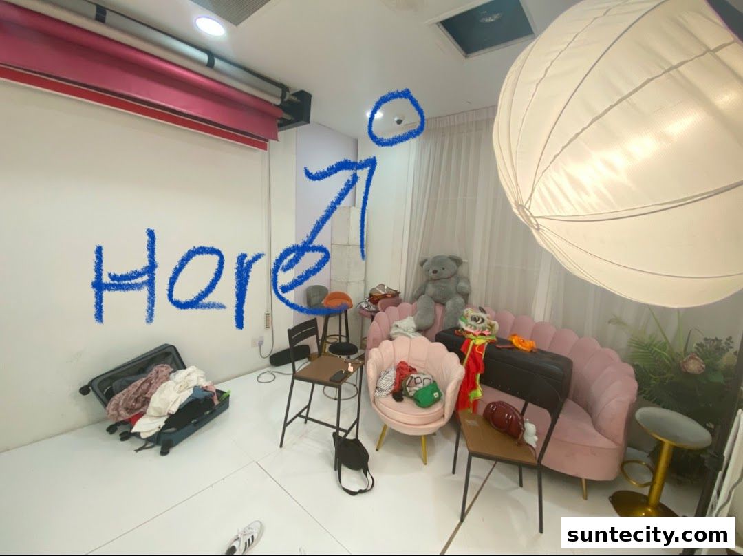 A studio space with furniture, props, and a large softbox light.