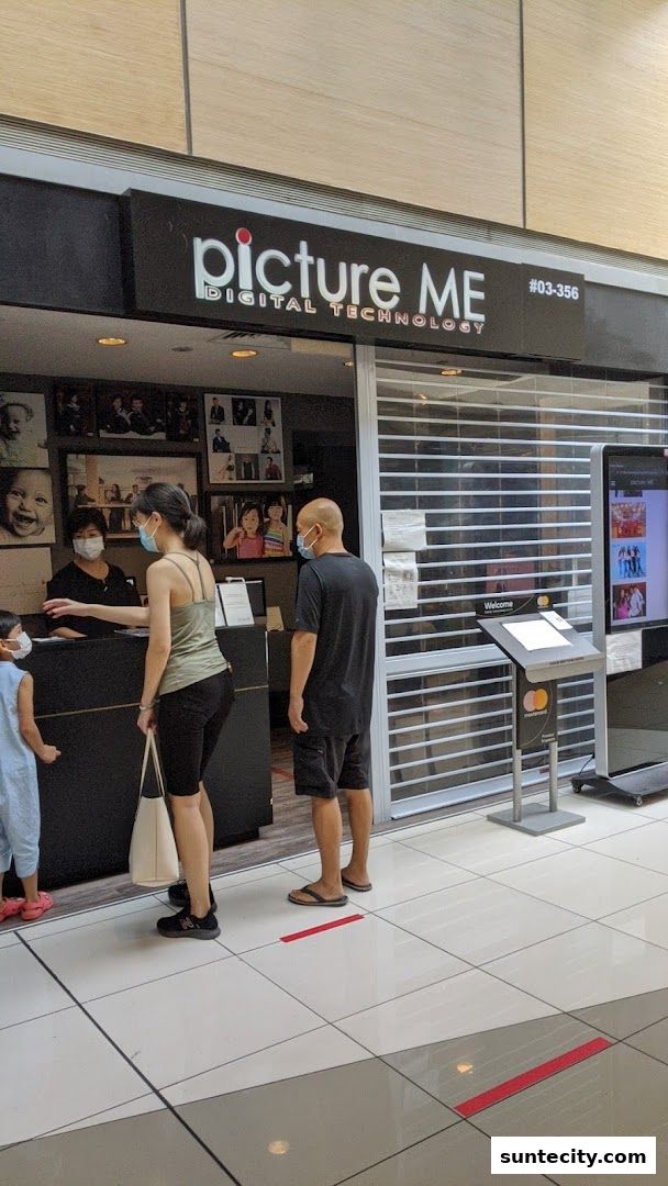 People queuing at the Picture Me digital technology photo studio entrance.