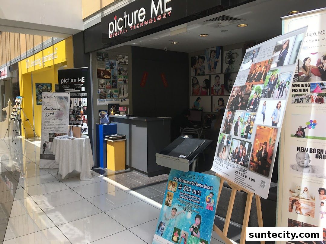 A photography studio shop front with promotional posters and displays of photos.