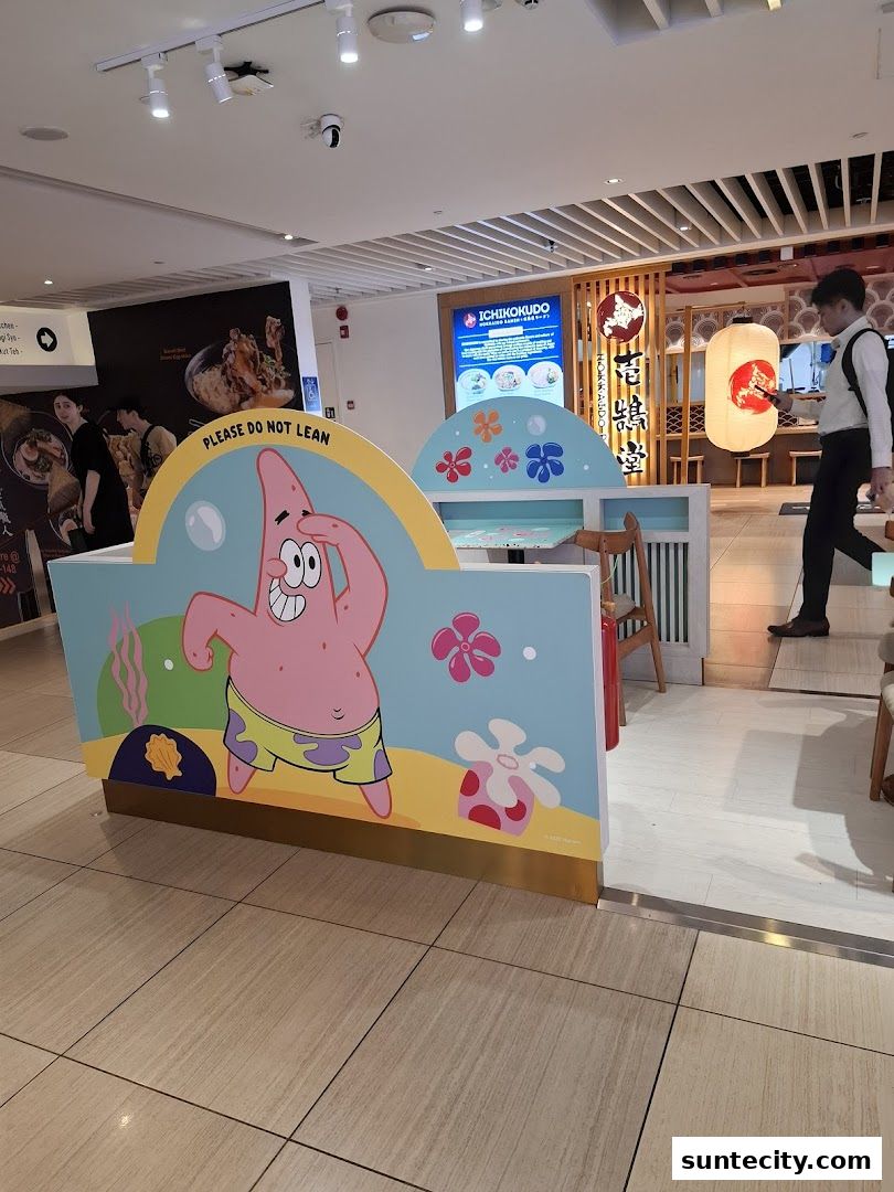 A playful display featuring Patrick Star from SpongeBob SquarePants outside a Japanese restaurant.