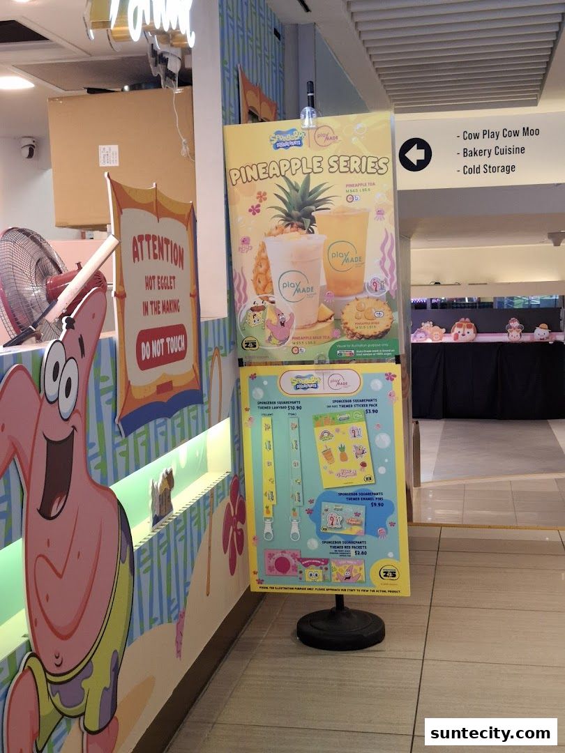 A sign displays Spongebob Squarepants themed merchandise and a pineapple drink series.