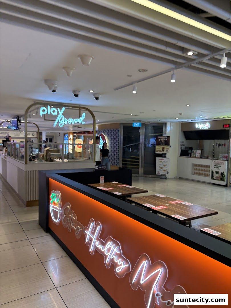 Interior view of Playground by PlayMade with neon signage and seating area.