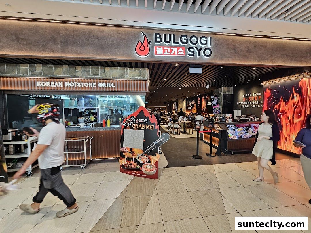 The exterior of a Korean street dining restaurant with a prominent sign and people dining inside.