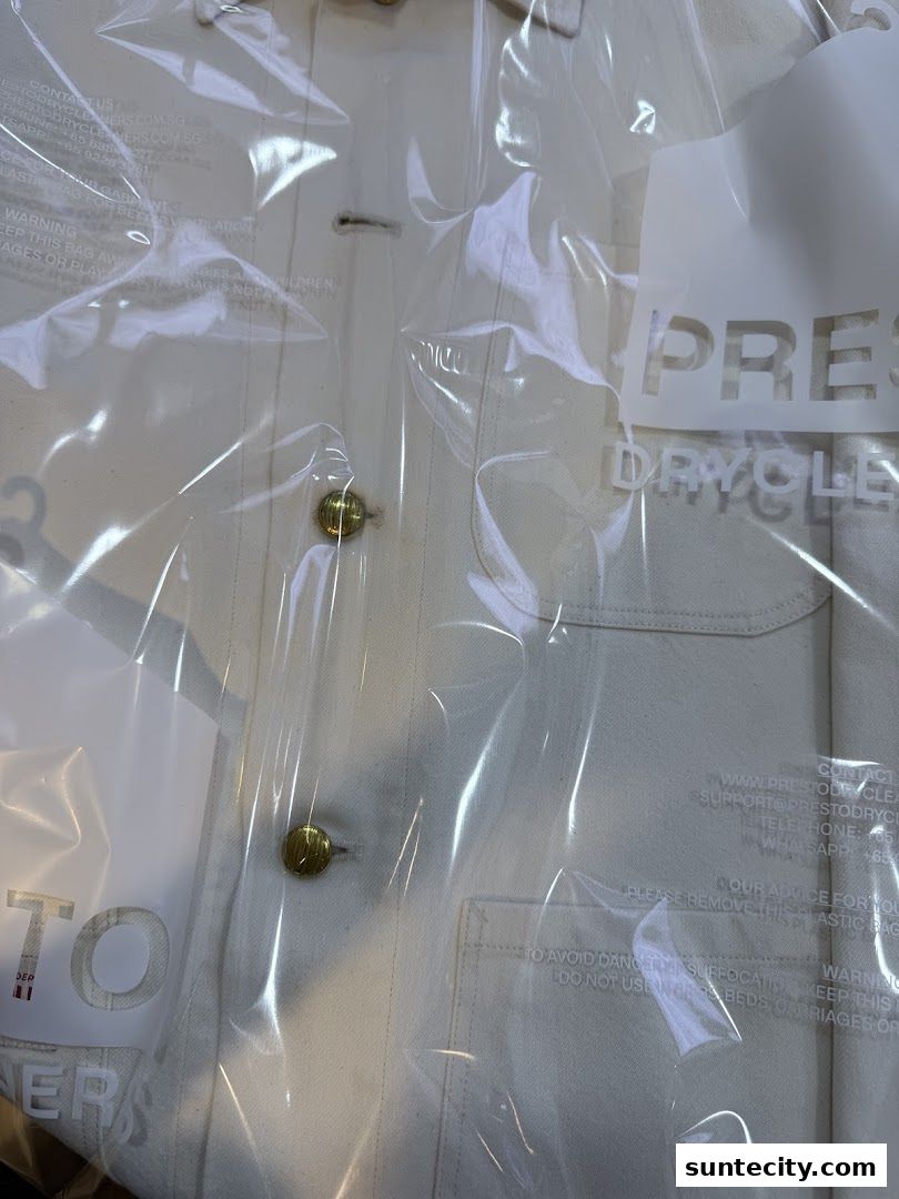 A garment in plastic packaging with the Presto Drycleaners logo visible.