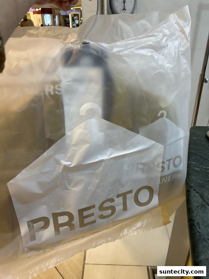 A plastic bag with the Presto Drycleaners logo and hangers visible inside.