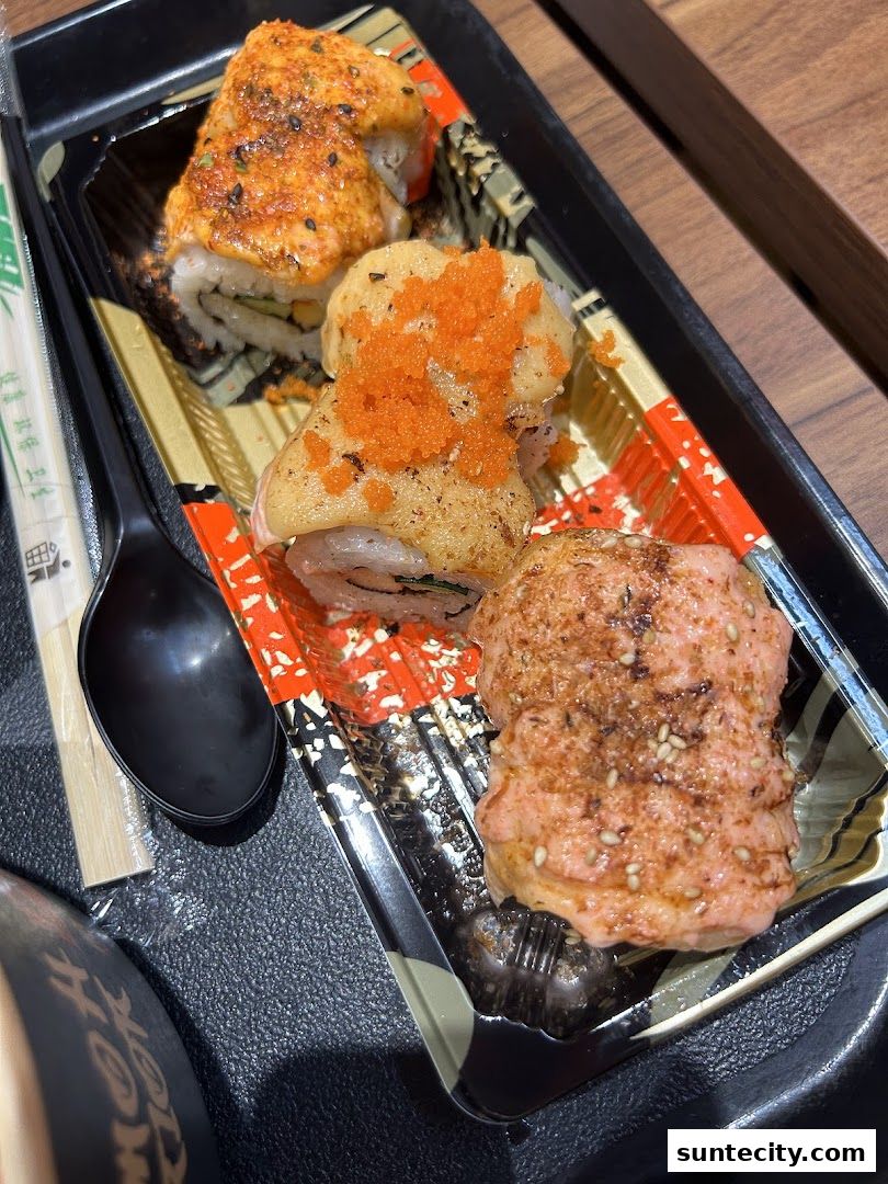 A close-up of a takeaway container filled with delicious-looking sushi rolls.