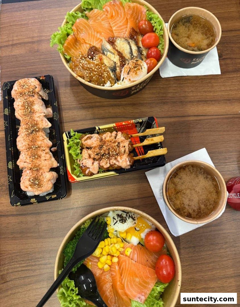 A table laden with delicious salmon dishes, including sushi, skewers, and rice bowls, with miso soup.