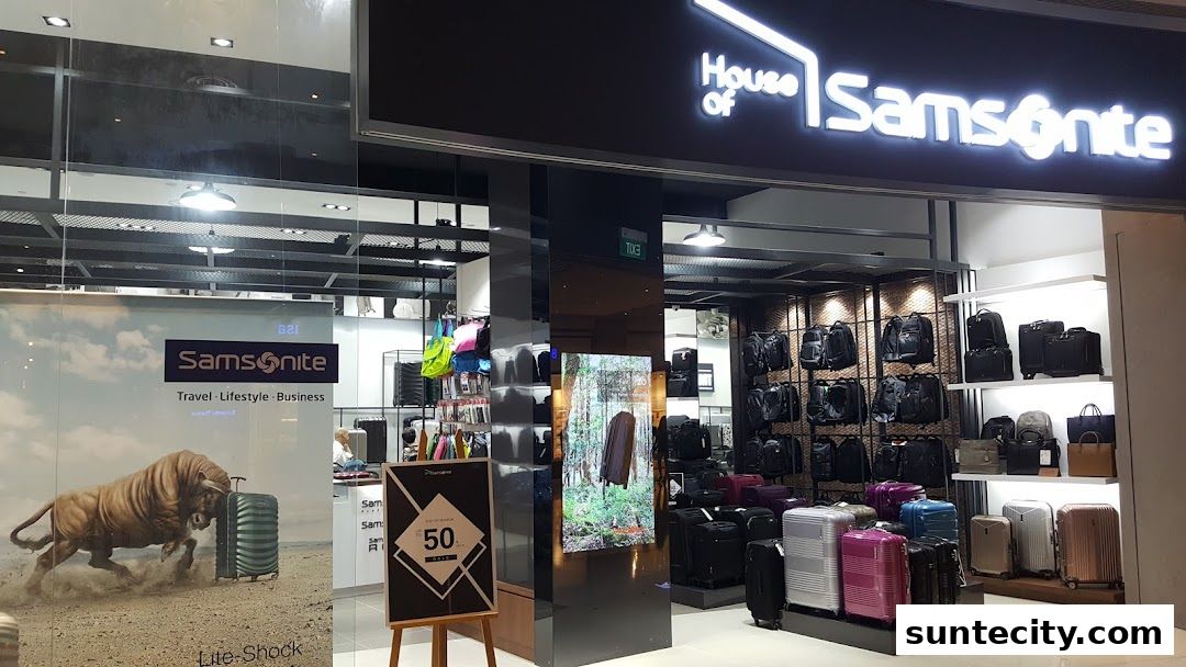 Samsonite store interior showcasing a wide variety of luggage and bags, with a promotional sign.