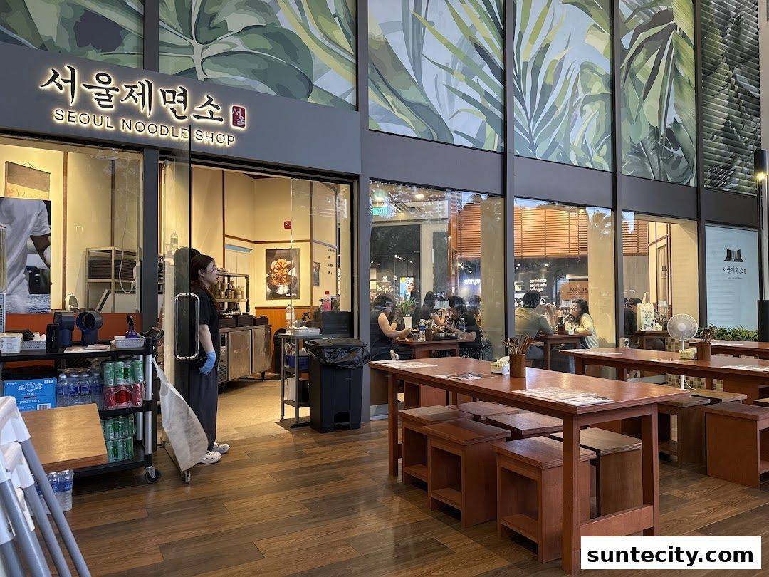 The exterior of Seoul Noodle Shop with tables and chairs set up outside.
