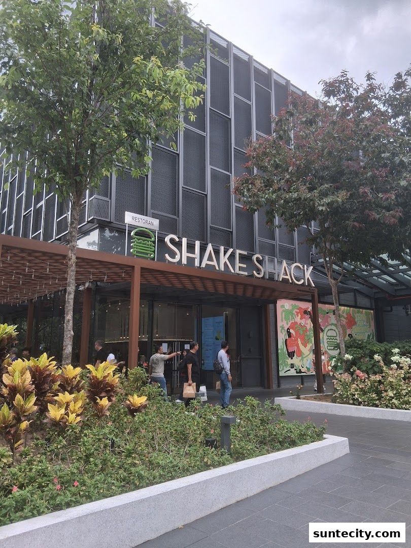 The exterior of the Shake Shack restaurant with its prominent signage and entrance.