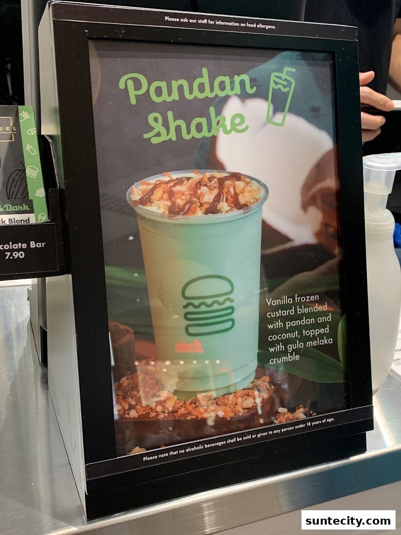 A sign advertising the Pandan Shake from Shake Shack, featuring a picture of the drink.