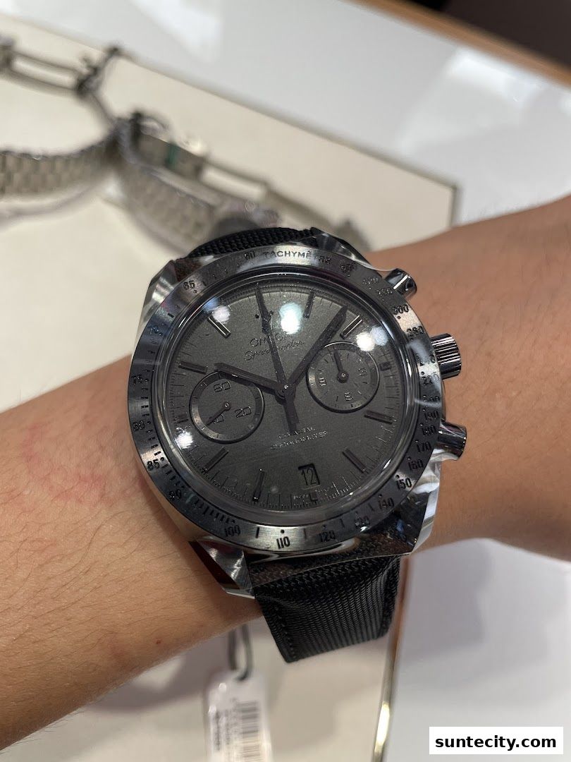 A close-up shot of an Omega Speedmaster watch on a person's wrist.