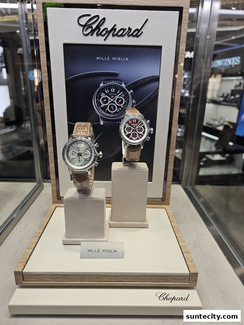 Display of two Chopard Mille Miglia watches with a promotional image.