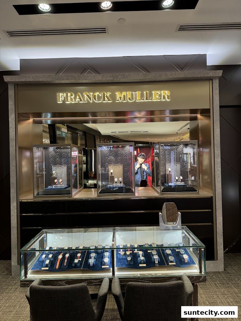 Franck Muller watch store display featuring luxury watches in glass cases and seating.