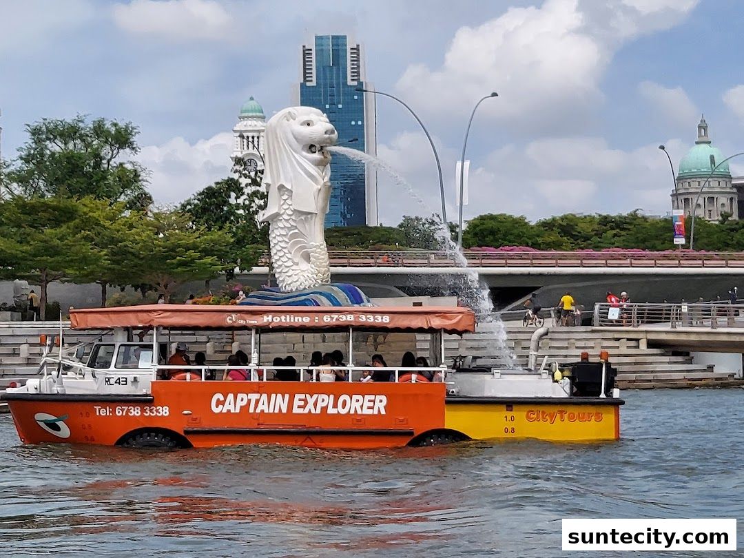 A DUCKtours boat named 'Captain Explorer' sails past the Merlion statue in Singapore.