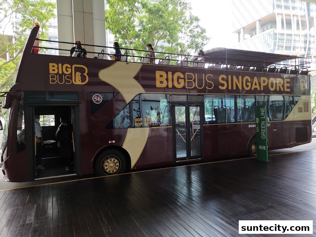 A double-decker Big Bus Singapore tour bus with passengers on the upper deck.