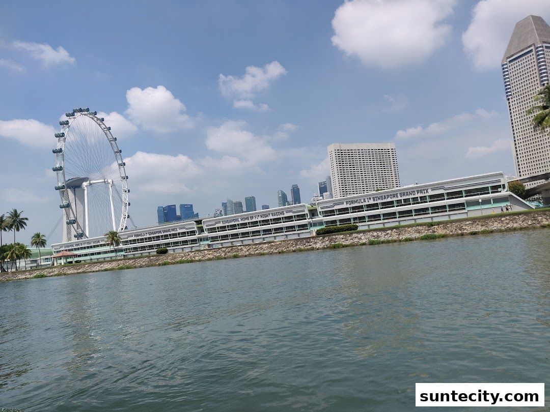 The Singapore Flyer Ferris wheel and the Formula 1 Singapore Grand Prix building by the water.