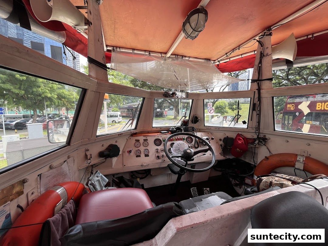 Interior view of the cockpit of a Duck tour vehicle, showing the steering wheel and dashboard.