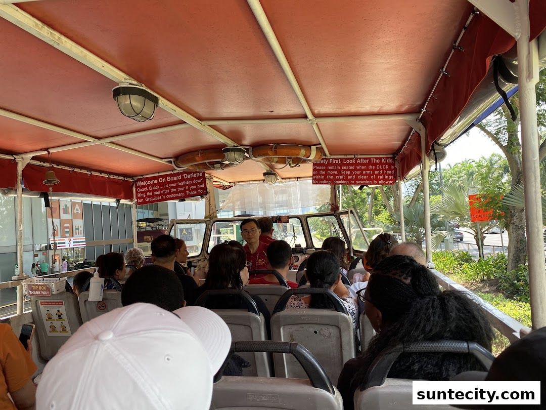 Passengers seated inside a DUCKtours vehicle, with safety instructions visible.