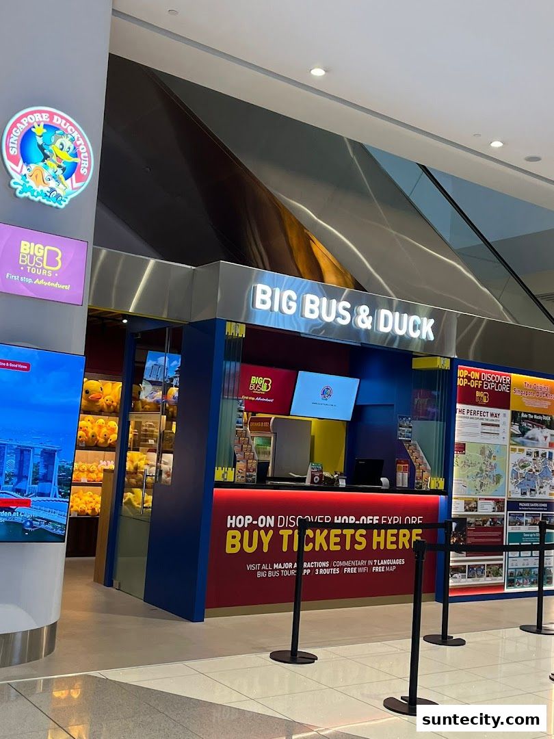 A ticket counter for Singapore DUCKtours and Big Bus Tours with promotional displays.