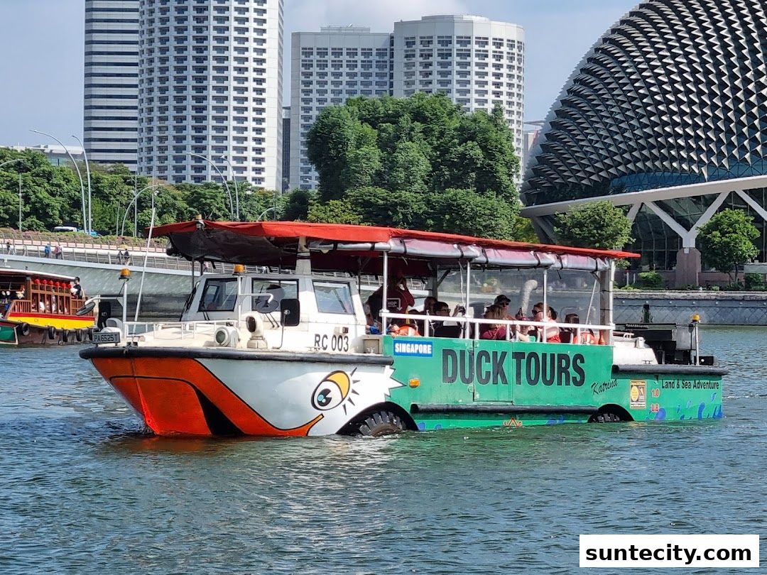A Singapore DUCKtours amphibious vehicle on the water with passengers.