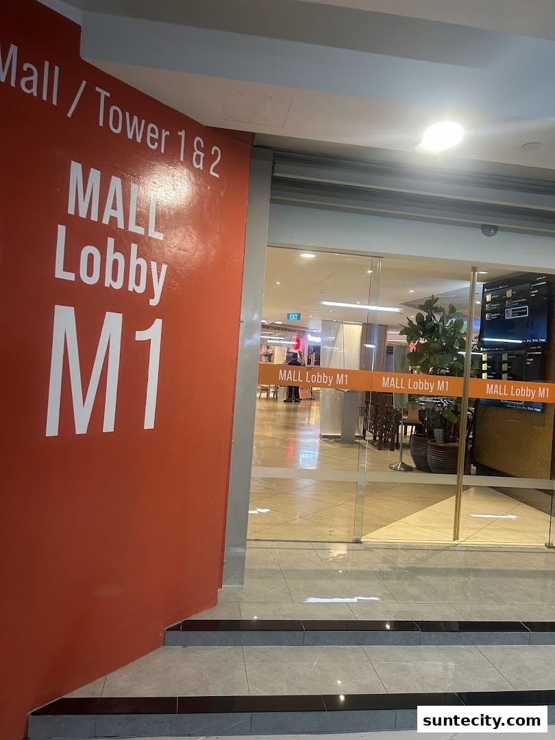 Entrance to Mall Lobby M1 with signage and glass doors.