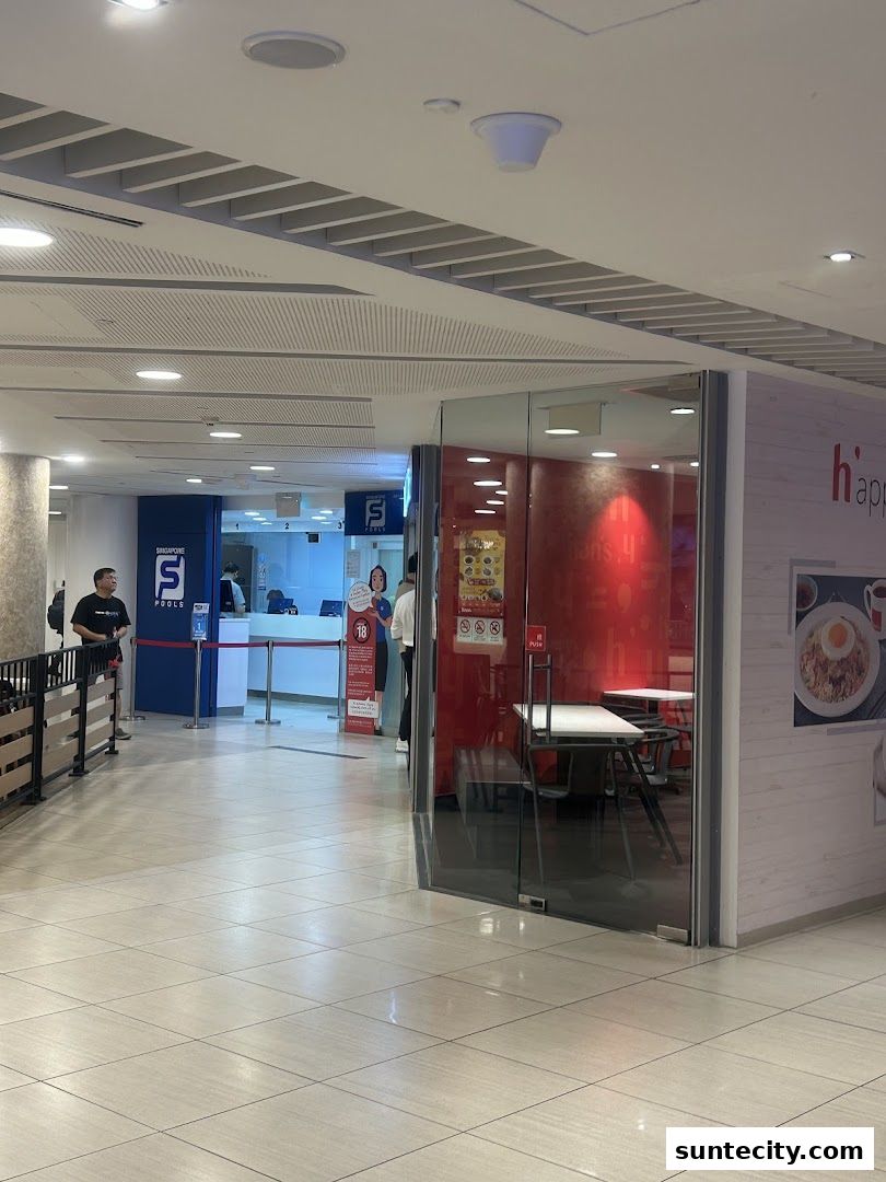 The entrance to Singapore Pools and a dining area with red walls and tables.