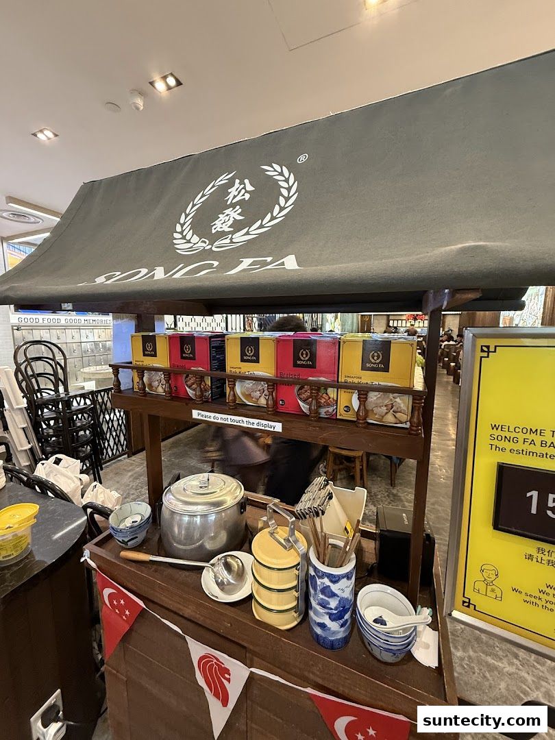 A display cart for Song Fa Bak Kut Teh with branded boxes and traditional serving ware.