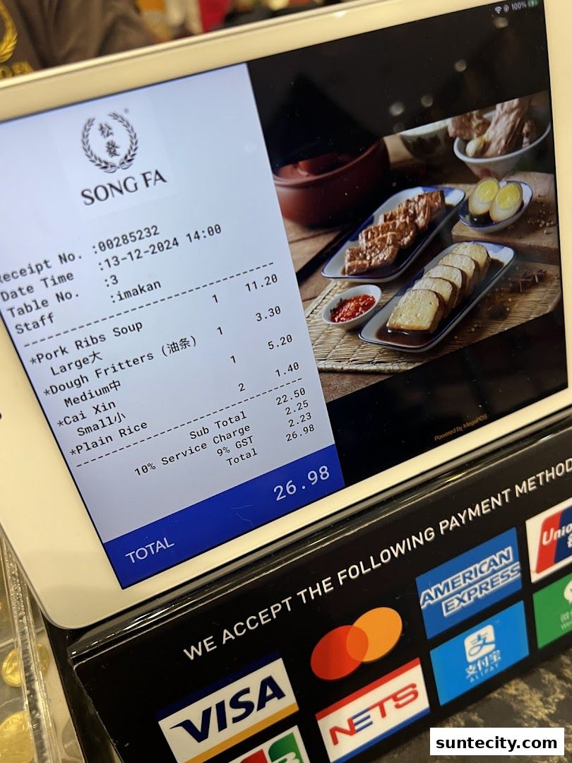 A receipt from Song Fa Bak Kut Teh displayed on a tablet, showing food items and payment methods.