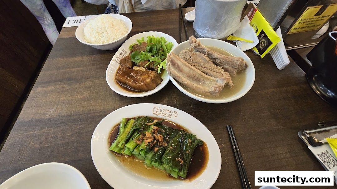 A table at Song Fa Bak Kut Teh with several dishes including pork ribs, braised pork, and vegetables.