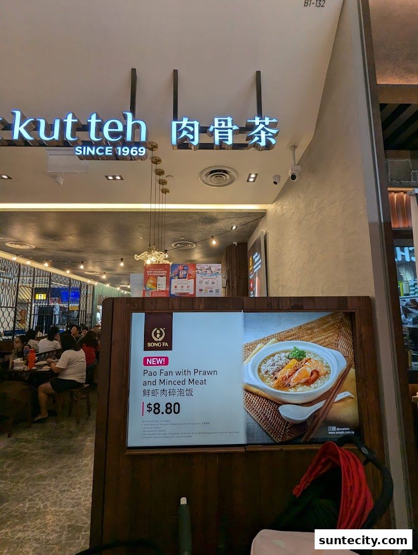 The entrance of Song Fa Bak Kut Teh, featuring its iconic sign and a promotional display.