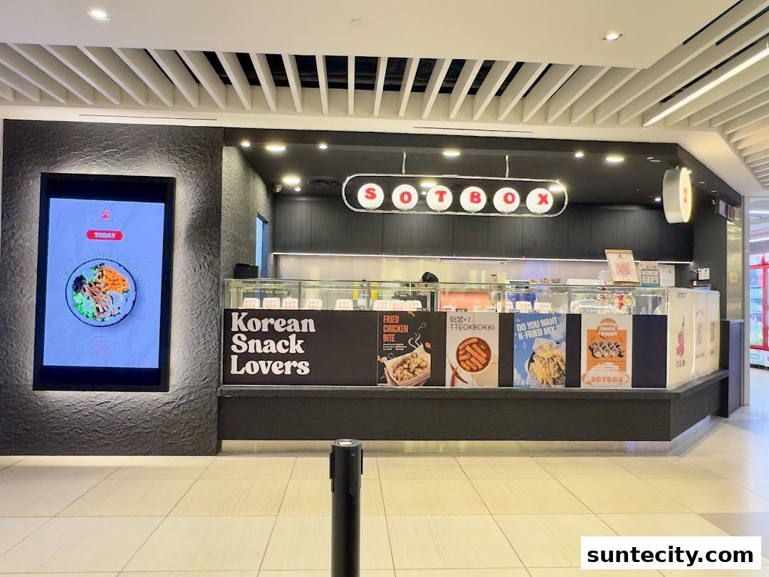 The SOTBOX shop front displays Korean snacks with vibrant posters and a digital menu.