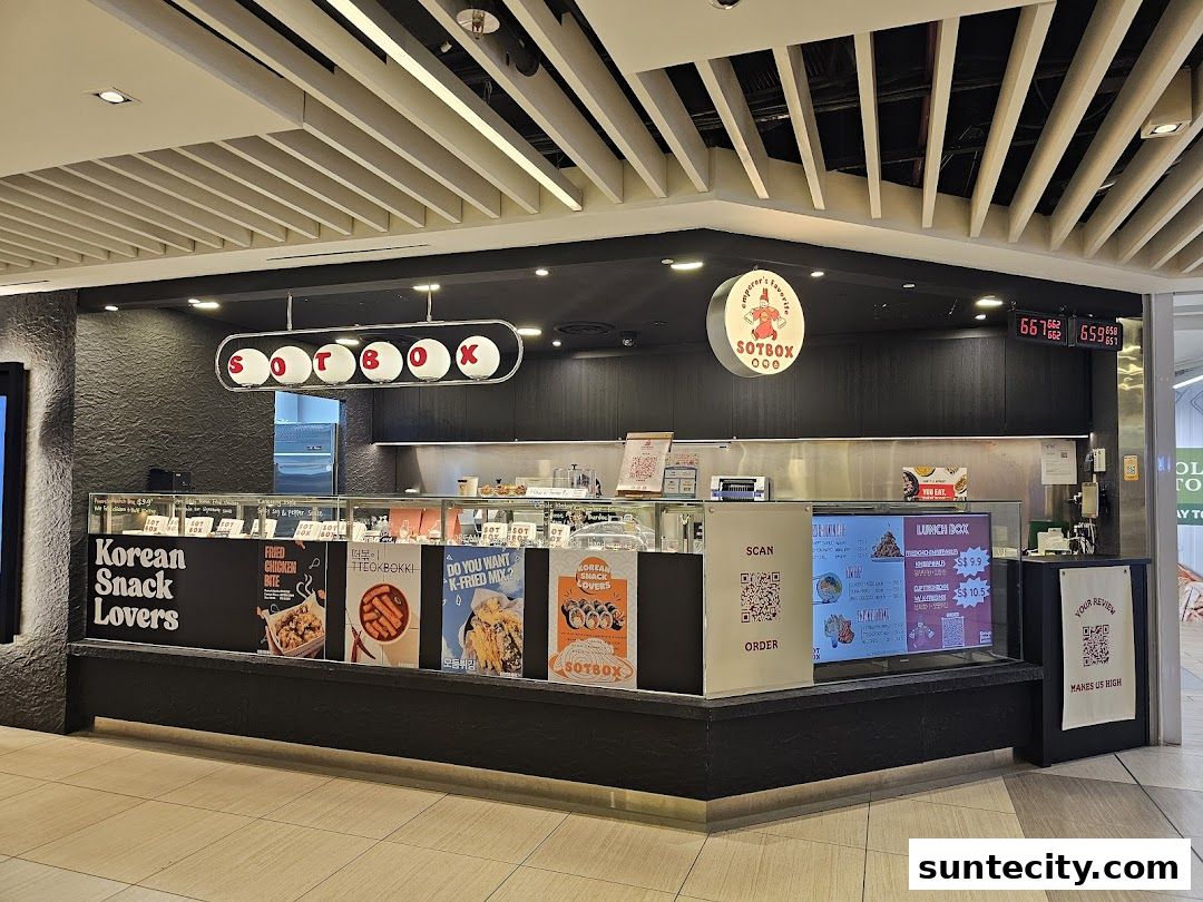 A modern Korean snack shop with vibrant food displays and clear signage.