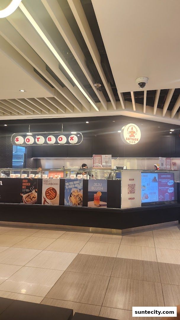The SOTBOX shop front displays vibrant menu posters and a digital menu board.