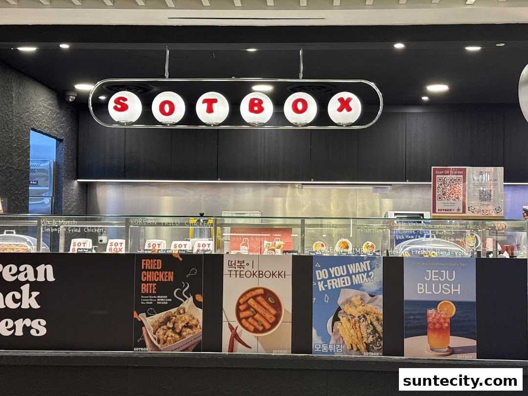 The front of a Korean food shop called SOTBOX, showcasing fried chicken and other dishes.