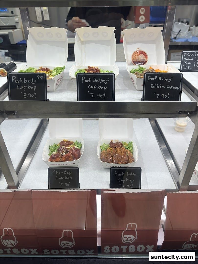 A display case showcasing various Korean cup bap dishes from Sotbox.