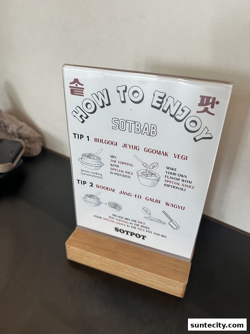 A sign from SOTPOT explains how to enjoy their SOTBAB dish with two tips.