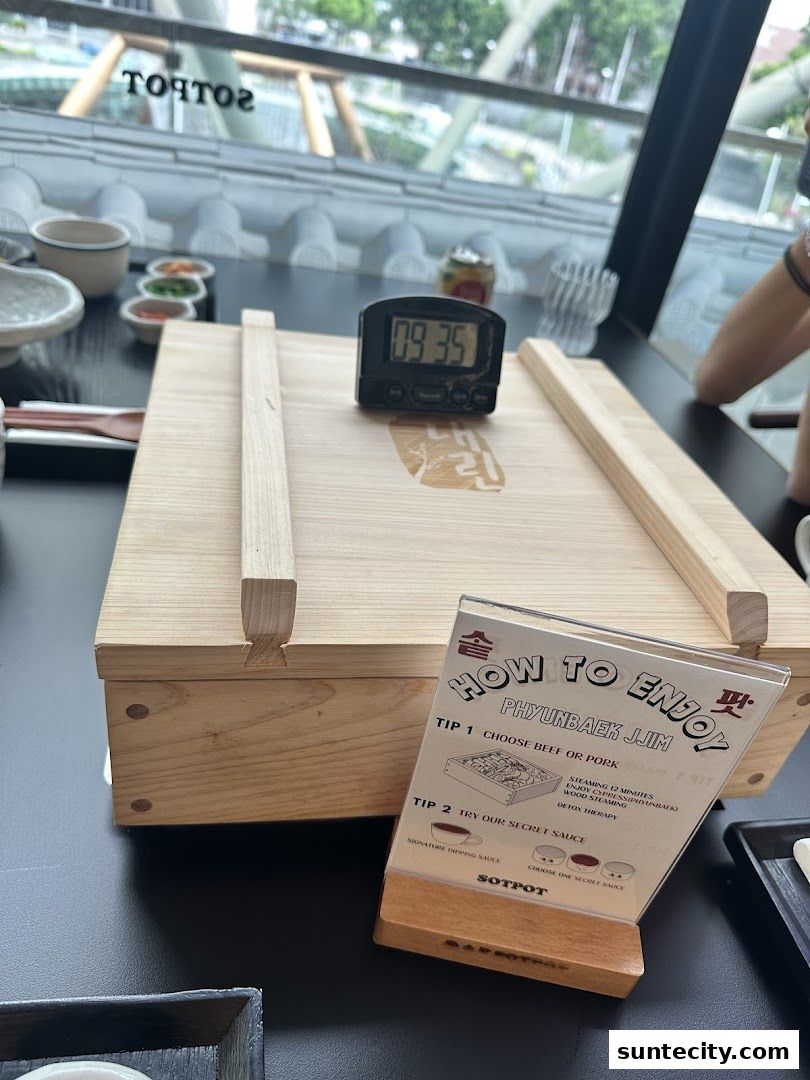 A wooden box with a timer and a 'How to Enjoy' guide for Phyunbaek Jjim at SOTPOT.