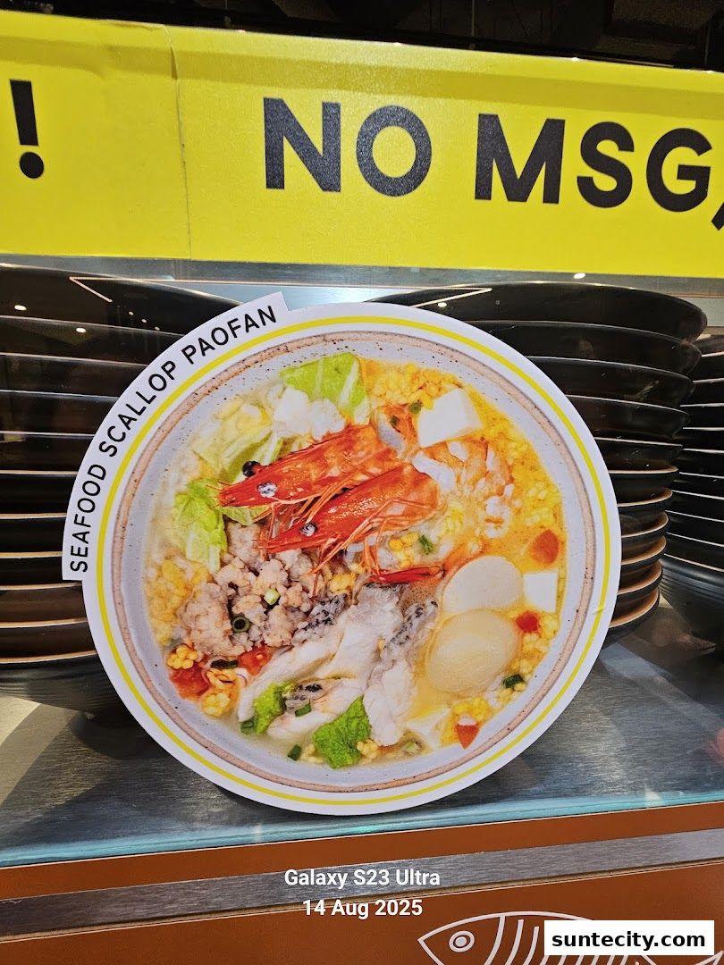 A close-up of a delicious seafood paofan dish with a 'NO MSG' sign in the background.