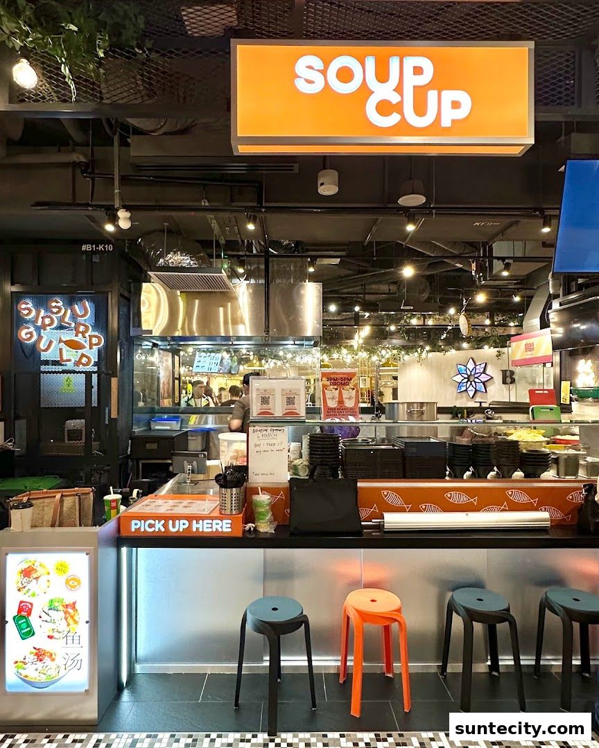The SoupCup Suntec City shop front with a prominent orange sign and a pick-up counter.