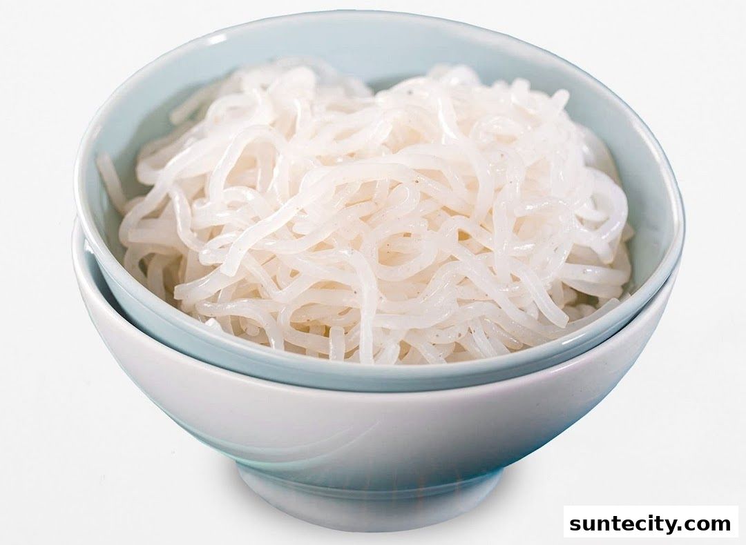 A close-up shot of a bowl filled with white konjac noodles.